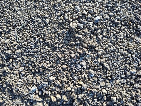Natural dark gray asphalt and crushed stone surface texture