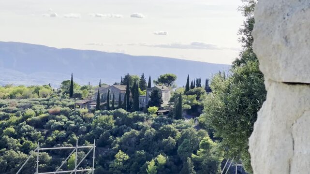 Traditional Provencal stone houses among cypress and olive trees