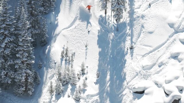 Action extreme sports snowboarder snowboarding drone follow deep fresh snow powder pillows cliffs drop air carve Rocky Mountain Vail Pass Colorado Epic Ikon Breckenridge Copper Mountain winter morning