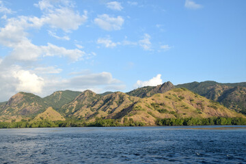 Fototapeta premium A beautiful landscape featuring cliffs and small hills around Padar and Rinca Islands, Labuan Bajo, Indonesia, on a clear morning.