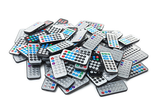 A pile of remotes isolated on a white background.