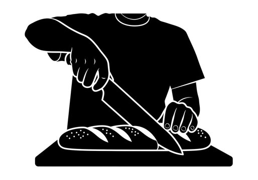 Chef slices a fresh loaf of crusty bread on a wooden cutting board using a sharp kitchen knife.