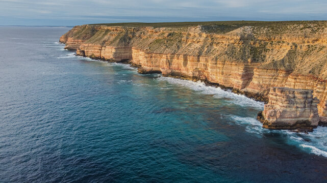 Wide aerial panorama of Island Rock and Natural Bridge coastal cliffs near Kalbarri, Western Australia. Massive sea stacks and vast ocean blue. Copy space. Travel, tourism
