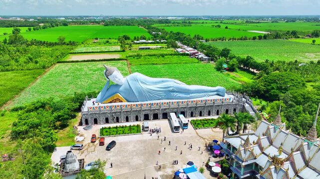 Majestic reclining Buddha statue at Som Rong Pagoda in Soc Trang, Vietnam, viewed from above on a bright sunny day. 