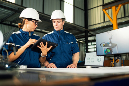 Teamwork in modern industry with detailed technical planning and collaboration.