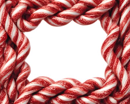 Festive red and white twisted candy cane frame forming a border with white copy space