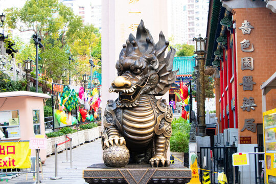 Hong Kong, January 21, 2026: Bronze statue of Pixiu (Pi Yao) and Qilin, traditional Chinese mythical guardian prominently at entrance of Wong Tai Sin Temple. Editorial image cultural and religious.
