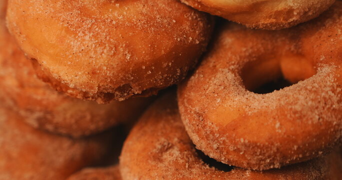 Stacked Homemade Golden Brown Sugar Cinnamon Donuts Close Up Macro Appetizing Baked Pastry Dessert Food Texture Comfort Treat