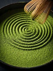 Naklejka premium Matcha powder zen ripples traced by a bamboo whisk in a dark bowl