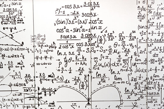 mathematical formulas, equations and geometric diagrams on chalkboard