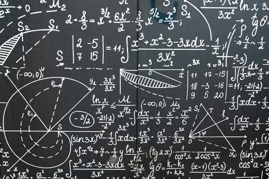 mathematical formulas, equations and geometric diagrams on black chalkboard