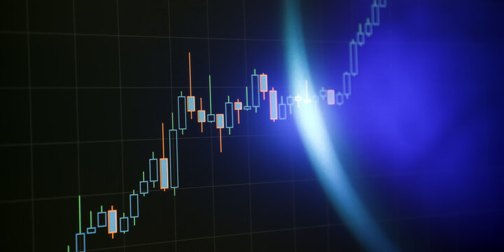 Futuristic stock market candlestick chart on digital screen with glowing blue light flare