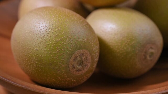 Fresh Yellow Kiwifruit in Wooden Bowl