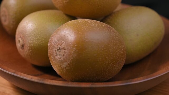 Fresh Yellow Kiwifruit in Wooden Bowl