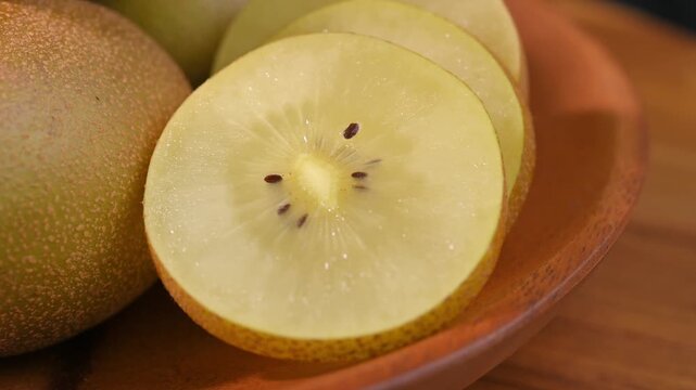 Fresh Yellow Kiwifruit in Wooden Bowl