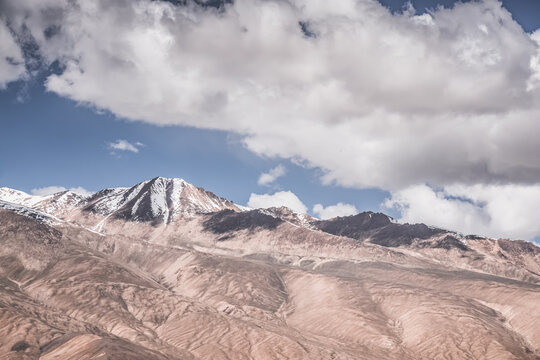 Rocky mountain slopes in the Pamir Mountains in Tajikistan, a minimalist landscape and rocky hills in sunny weather