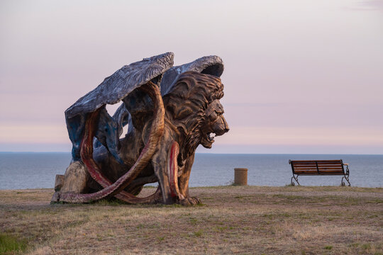 MERZHANOVO, RUSSIA - MAY 06, 2025: Sculpture of a manticore on the background of the Sea of Azov on a May evening. Охуland park. Rostov region