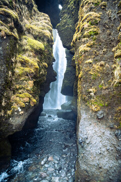 Vertical photo of the entrance to the Gljufrabui waterfall hidden in a canyon near Seljalandsfoss on a March day