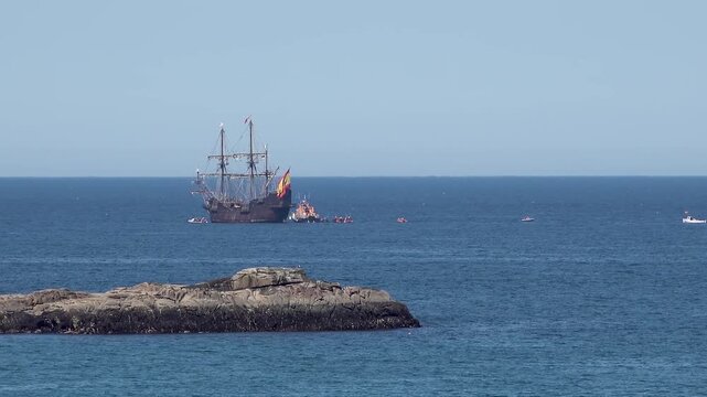 Historic Galleon with Spanish flag sailing close to the coast of Ireland in County Donegal