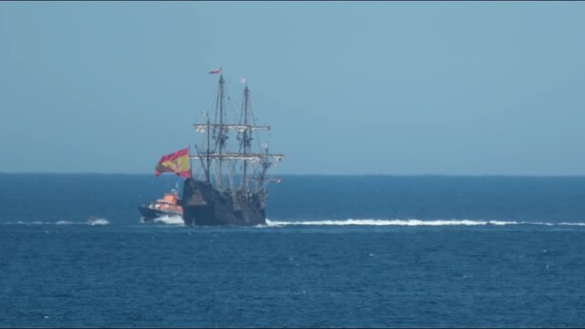 Historic Galleon with Spanish flag sailing close to the coast of Ireland in County Donegal
