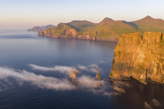 The Risin og Kellingin pinnacles off the Eysturoy cliffs in the evening light, Faroe Islands, Denmark