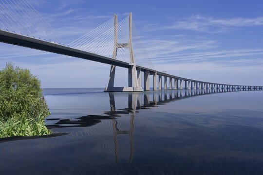 Cable-stayed Vasco da Gama Bridge reflecting in Tagus River, Lisbon, Portugal