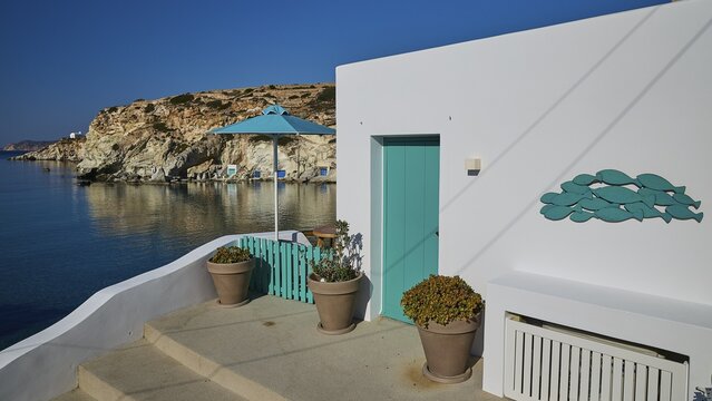 Terrace with green railing and sea view on rocky coast, Syrmata, boat garages, boathouse, boathouses, beach house, Goupa, Goypa, Goupa Kara, Kimolos, Cyclades, Greek Islands, Greece
