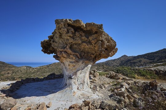 Impressive rock formation rises in front of an extensive mountain range, mushroom rocks, mushroom rock, bizarre rocks, rock formation, Skiadi, Kimolos, Cyclades, Greek Islands, Greece