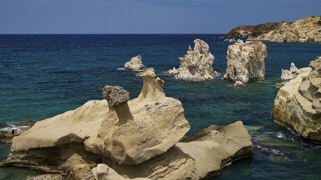 Dramatic rock formations on the edge of the deep blue ocean, Aspragremna, White Cliffs, Mavorspilia Beach, Kimolos Island, Kimolos, Cyclades, Greek Islands, Greece