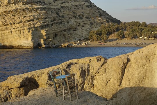 Neolithic caves, former hippie paradise, empty chairs on a rock by the sea, peaceful and natural environment, Matala, south coast, Crete, Greek Islands, Greece