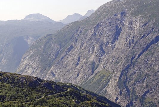 Extensive view of impressive rock formations and green valleys and a gravel road in the fells, Eikesdalen, Aursj&ouml;vegen, More og Romsdal, Norway