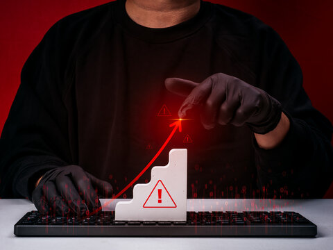 Scammer draw rising red arrow on graph. Cybercriminal driving rising online fraud, scam growth, increasing cyber threats, phishing attacks, financial crime, cybersecurity risks, digital fraud trends.