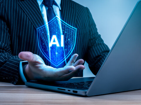 Business professional holding AI security shield hologram. Enterprise protection, responsible governance, regulatory compliance, trustworthy artificial intelligence, secure digital systems concept.