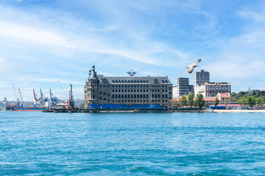 Istanbul, Turkey: May 17, 2026: Historic Haydarpaşa Train Station and port viewed from sea with flying seagull in Kadık&ouml;y