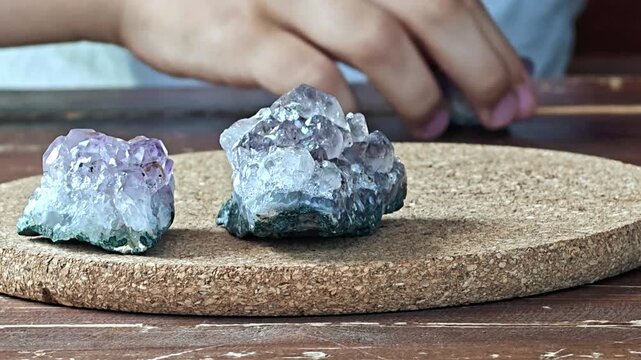 Natural mineral amethyst in hand. Semi-precious multi-colored stones, minerals close-up. Mineralogy. Mineral collection.