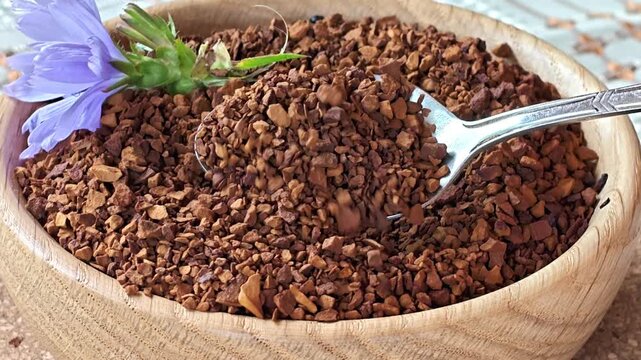 Ground chicory root, chicory flowers and chicory drink on a rustic wooden background. Alternative medicine. Healthy drinks