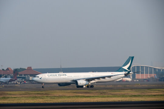 Jakarta, Indonesia - July 15, 2026: Cathay Pacific Airbus A330 accelerating on the runway for takeoff at Soekarno-Hatta International Airport.