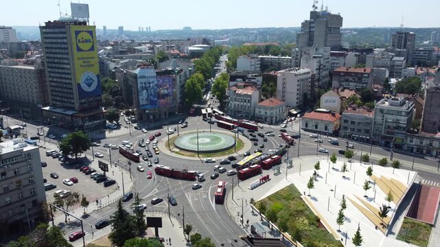 Aerial view rotating around Slavija Square roundabout with a central fountain in downtown Belgrade, Serbia.