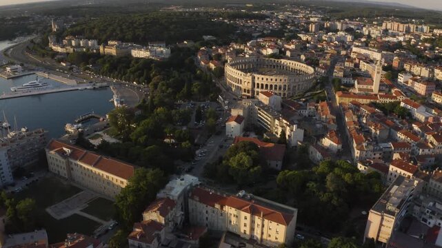Drone view of Pula Arena as the drone flies up and the camera pans down