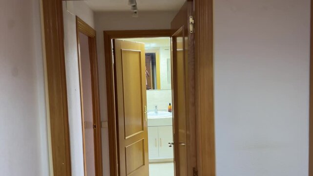 Painter man sanding a wooden door frame before painting