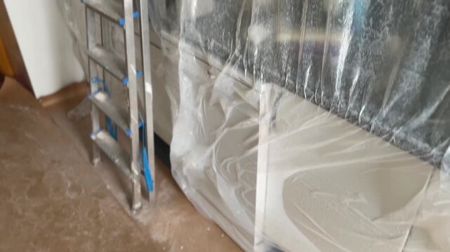 Room renovation with furniture covered for protection
