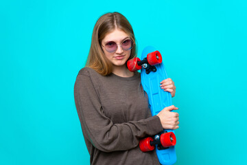 Teenager skater girl isolated on blue background © luismolinero
