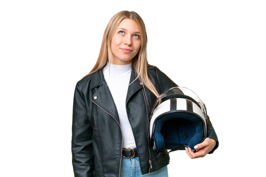Young pretty blonde woman with a motorcycle helmet over isolated chroma key background and looking up