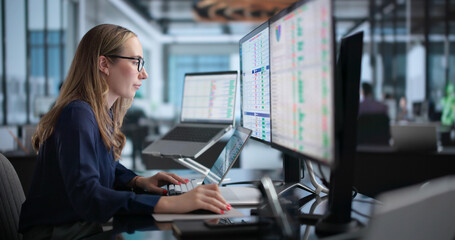 Woman In Office Using Laptop