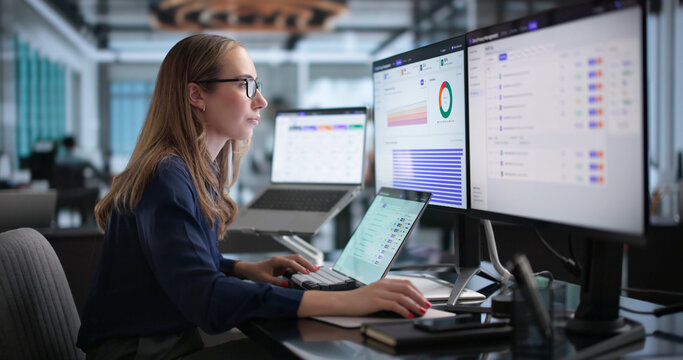 Young Woman Reviews Data Privacy Compliance Dashboard On Laptop