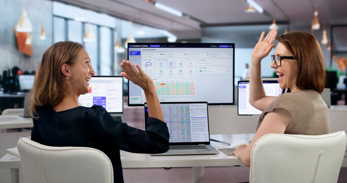Woman Attentively Checks Employee Training Progress On Laptop