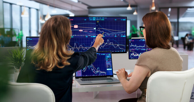 Woman Studies Stock Charts On Computer Screens