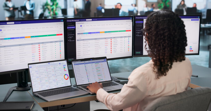 African Woman IT Manager Reviewing Risk Dashboard On Laptop