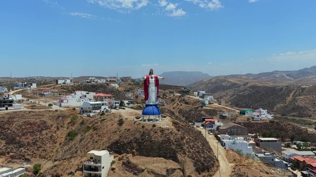 Aerial view of Cristo del Sagrado Coraz&oacute;n monument overlooking the hills of Rosarito, Baja California, Mexico with surrounding residential neighborhoods