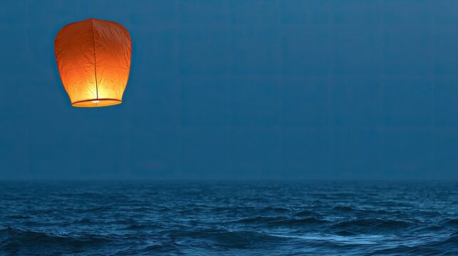 Glowing lantern ascends over dark, rippling ocean under a twilight sky